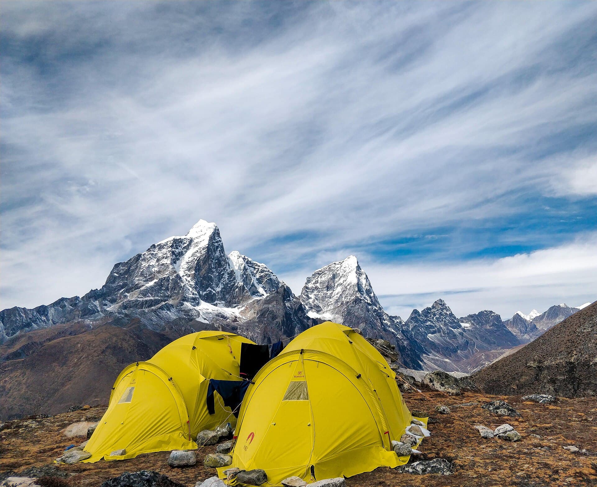 Mount Ama Dablam towering over green alpine meadows in Nepal
